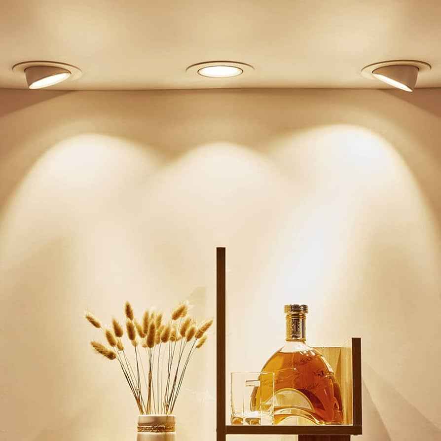 NJS Downlights illuminating a decorative bottle with a glass of wine