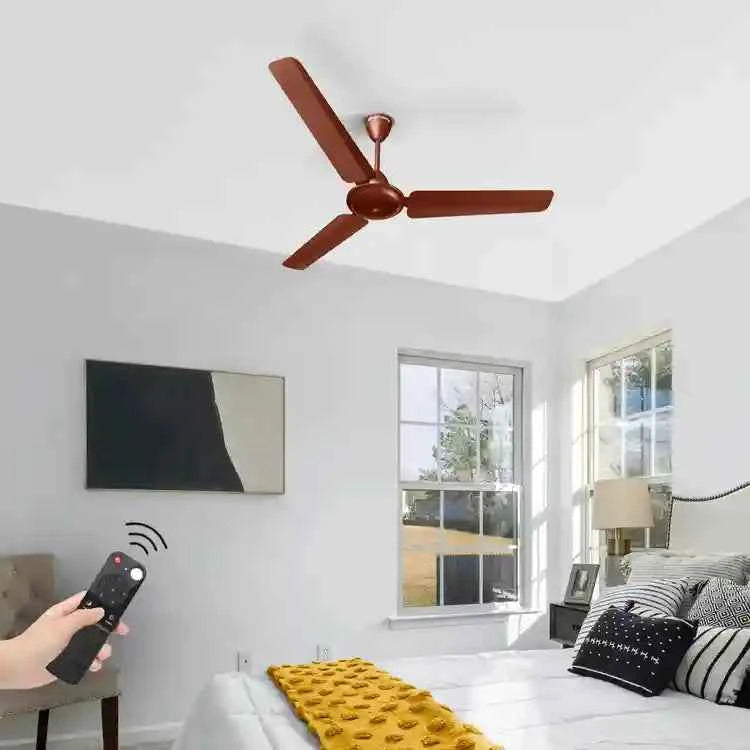 Ceiling fan in a room with a hand holding a remote control