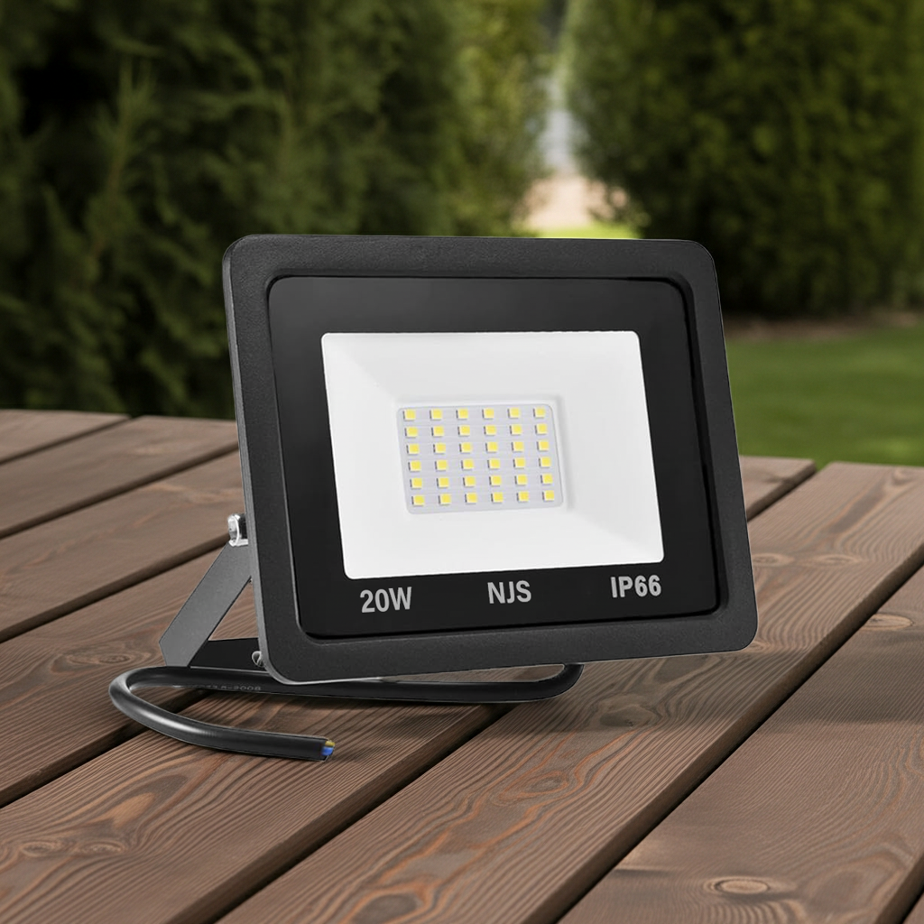 LED flood light on a wooden surface with a blurred natural background